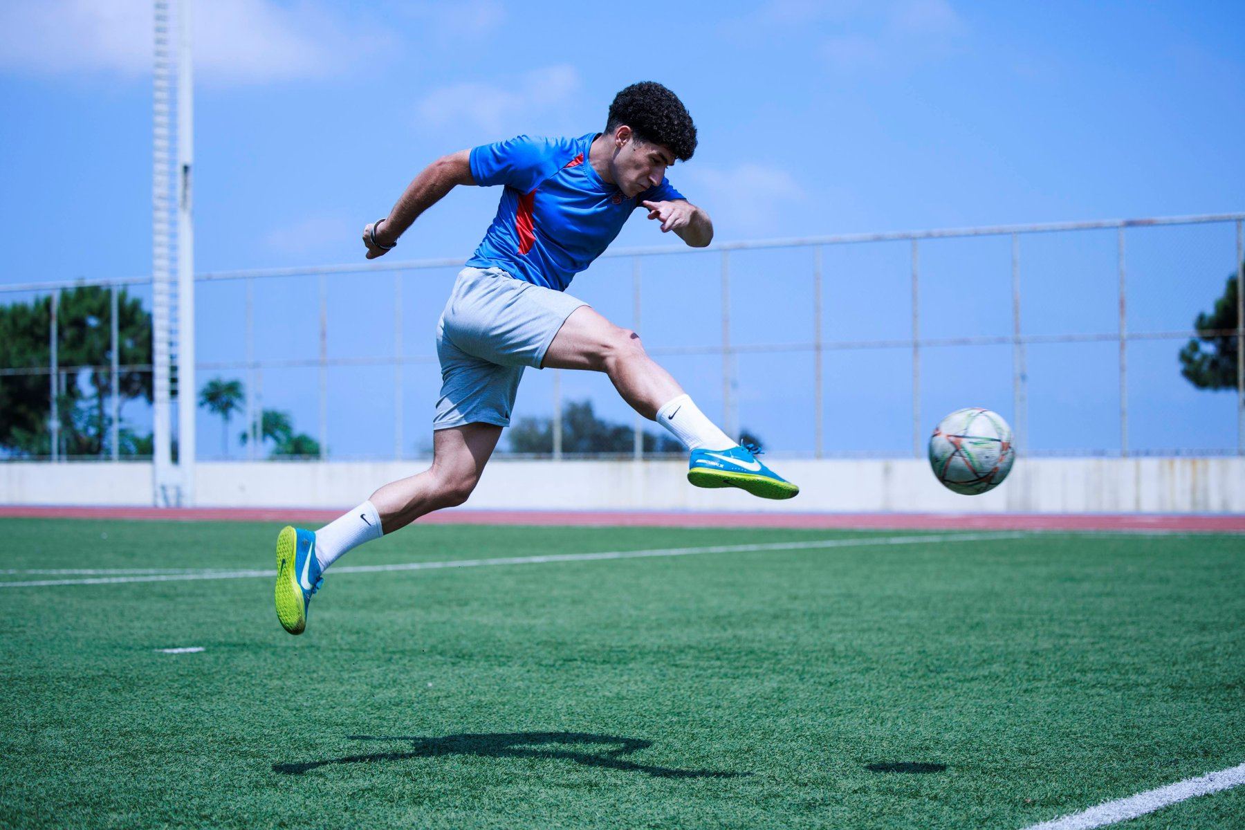 SAS student striking a football